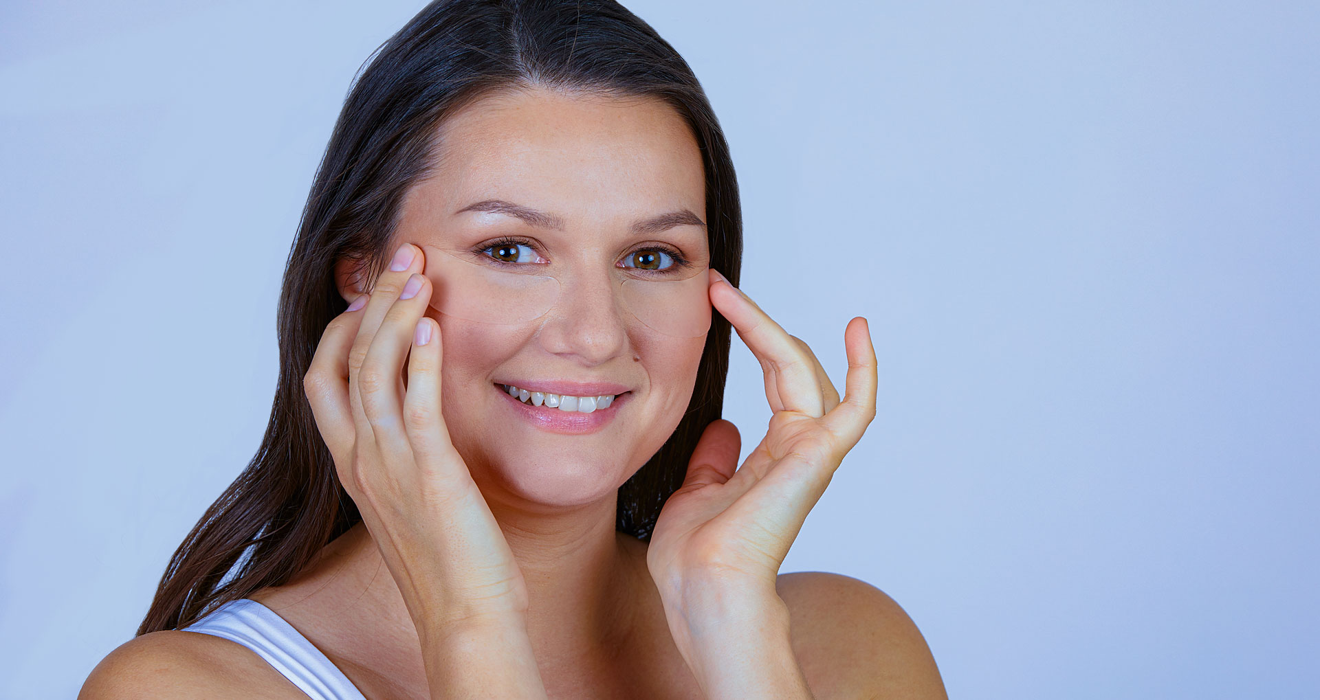 Woman applying SilcSkin Eye pads